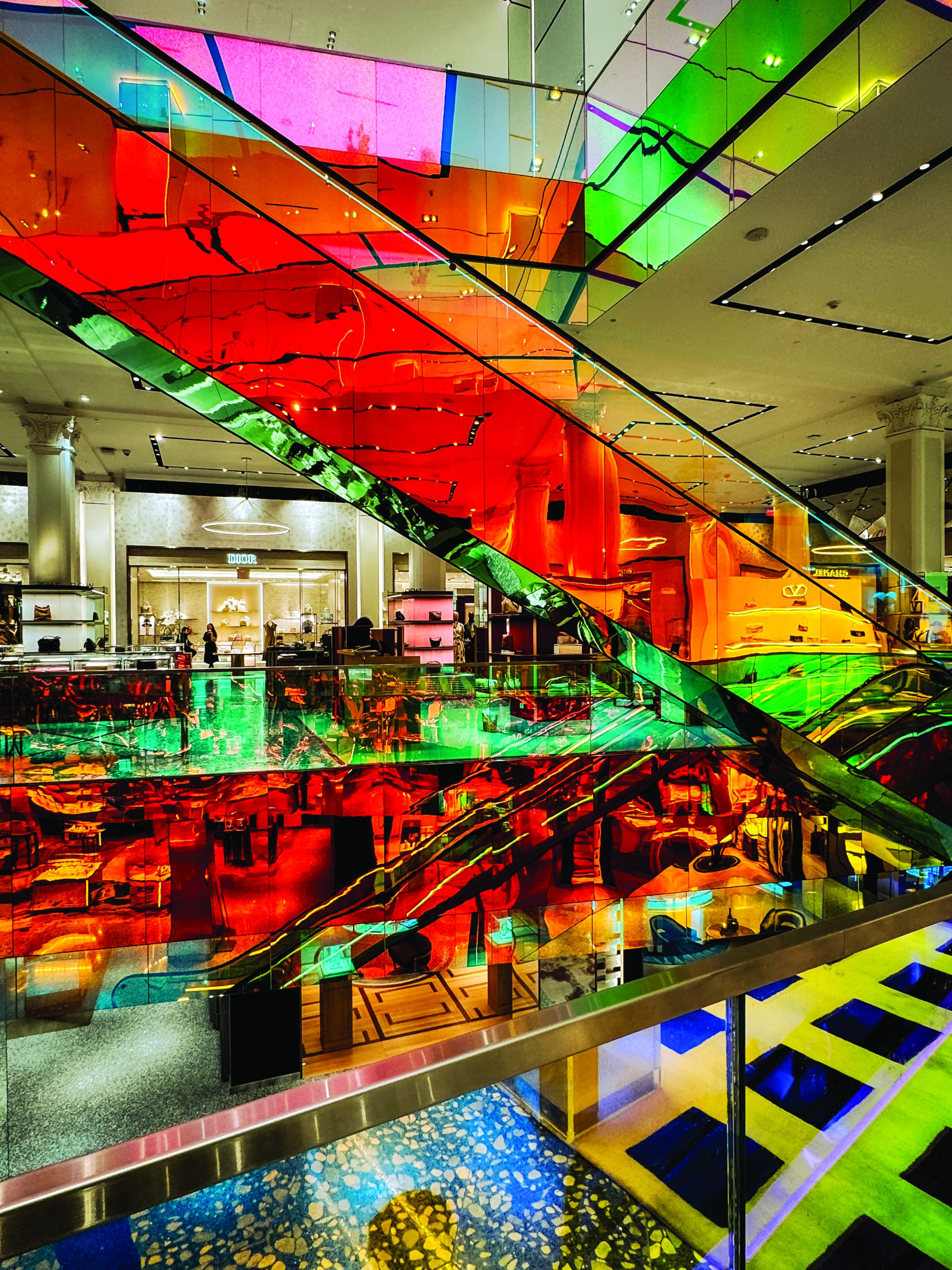New York, New York - May 21, 2025: Colorful escalators in Saks Fifth Avenue in NYC